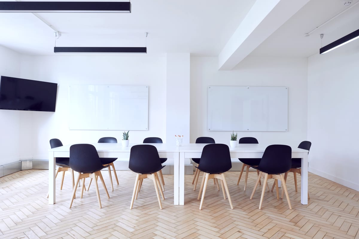 Bright open-plan office desks, cleaned and reset